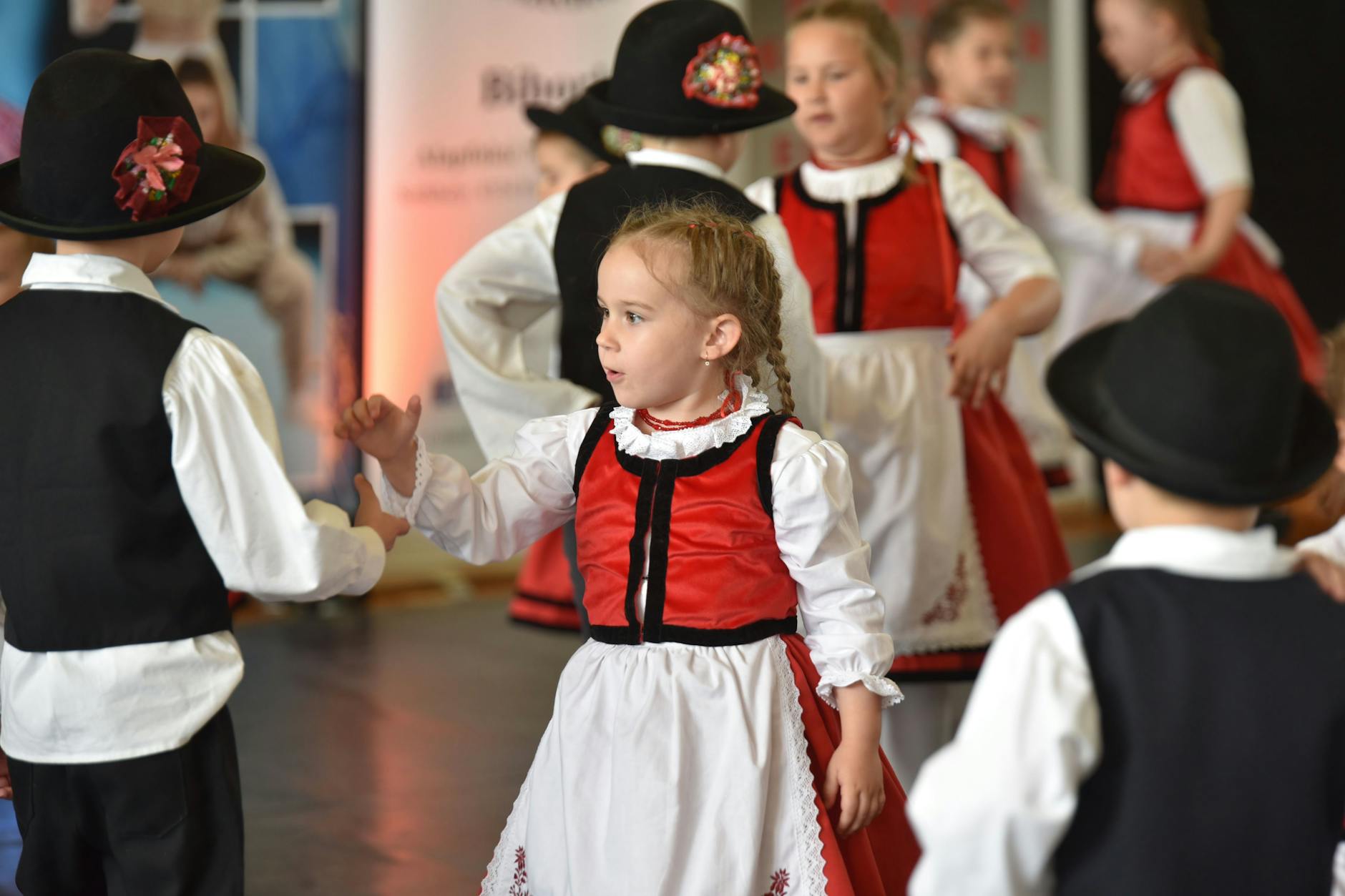 Uśmiechnięte dziecko oglądające przedstawienie teatralne lub bajkę, symbol wydarzeń kulturalnych dla dzieci w Radomiu